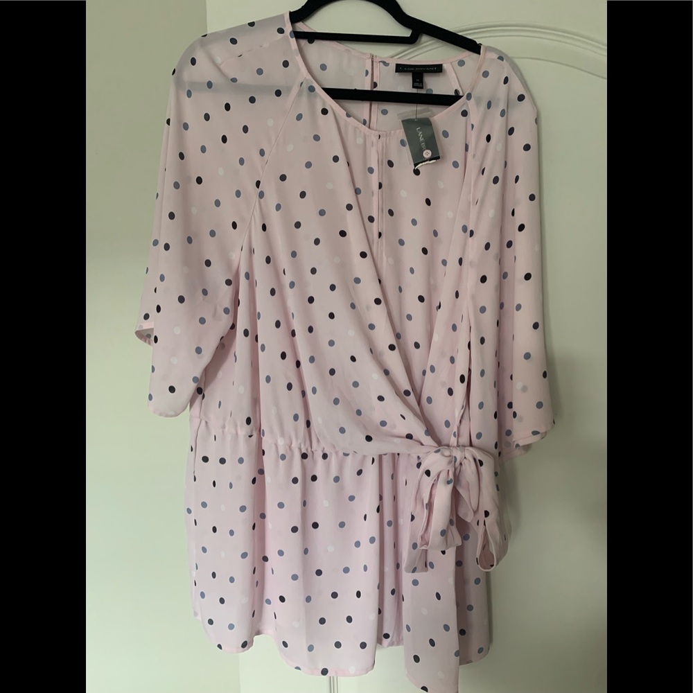 Pink blouse with blue polka dots. Tie bow at waist